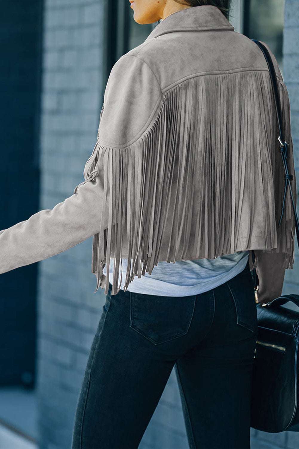Back view of gray cropped fringe faux suede jacket for women, featuring long fringe detail across the back and sleeves, ideal for fall layering.