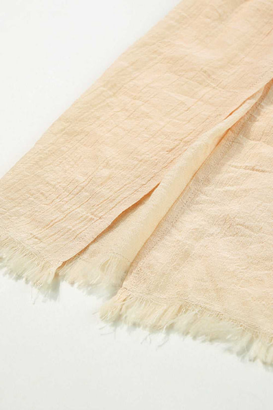 Detail of beige shirred beach skirt fabric and split