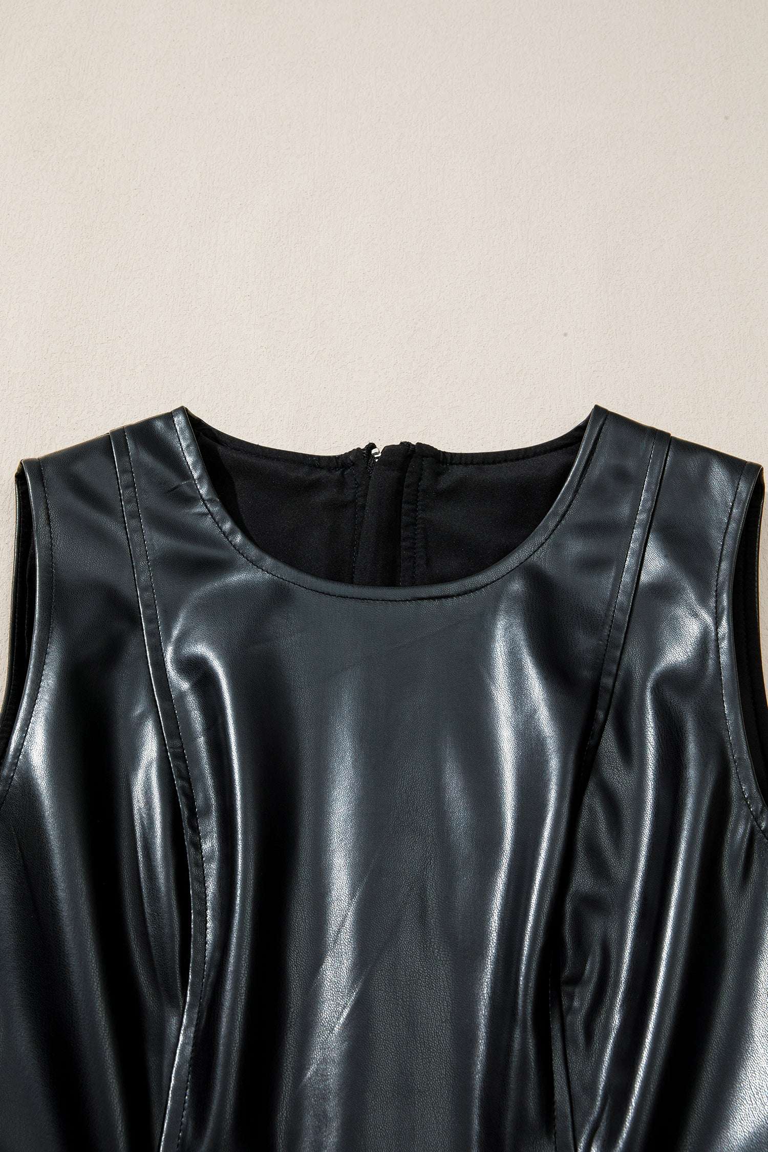 Close-up of neckline on Ladies Black Faux Leather Mini Dress | FashionFitz showcasing round neck and smooth PU leather finish.