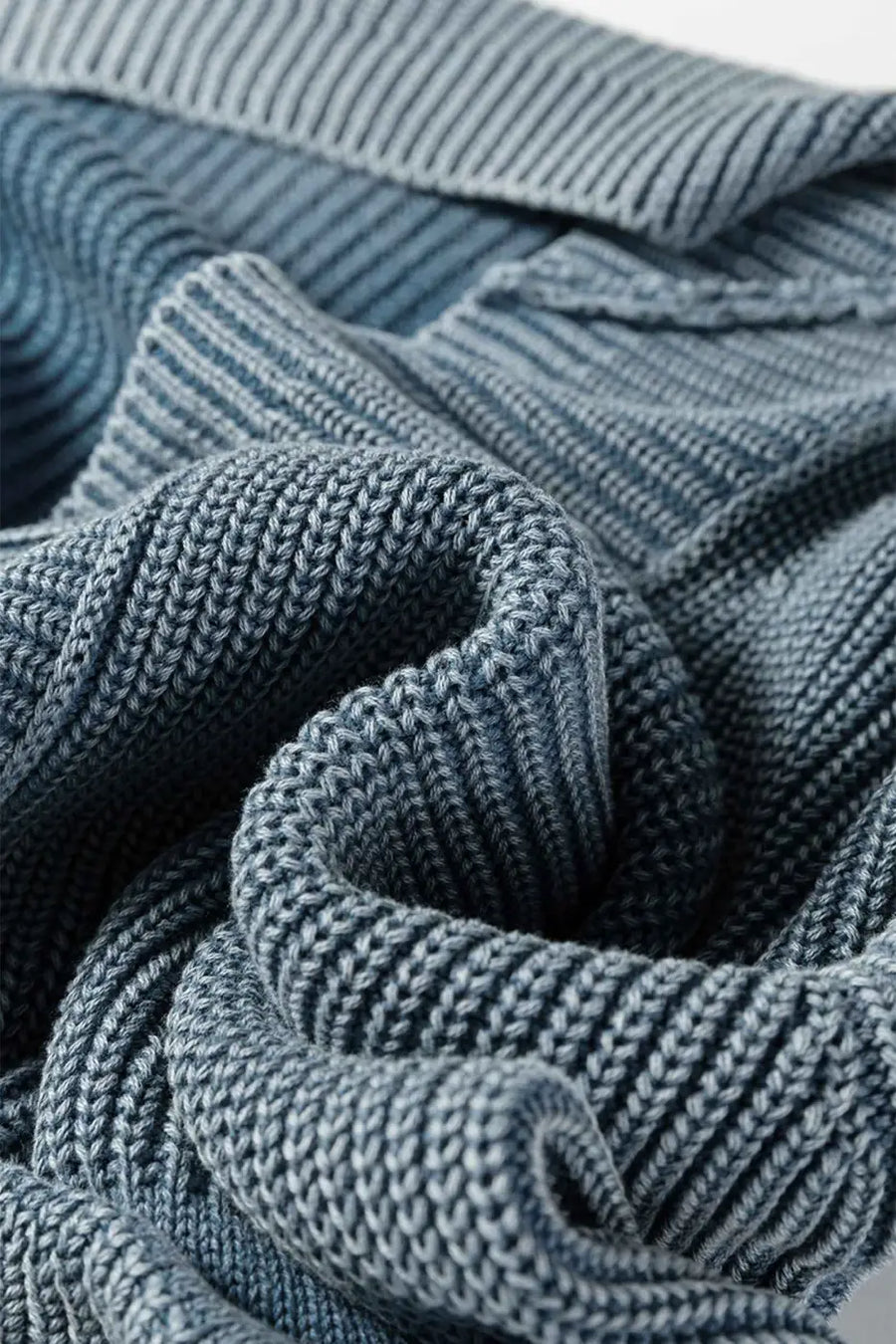 Soft, folded blue knit fabric of Women's Stonewash Patchwork Knit Open Cardigan, emphasizing cozy texture and quality.