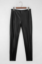 Flat lay of Black Vegan Leather Leggings – High‑Rise Skinny Fit showing front seam detailing and sleek faux leather texture.