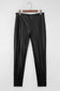 Flat lay of Black Vegan Leather Leggings – High‑Rise Skinny Fit showing front seam detailing and sleek faux leather texture.