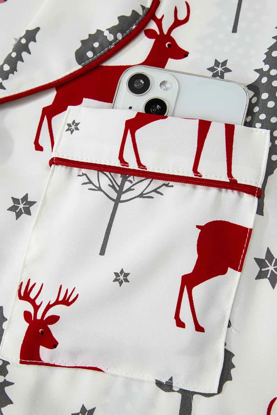 Pocket detail on Ladies White Christmas Print Velvet Trim Pyjamas with red piping and smartphone storage, combining function and festive style.