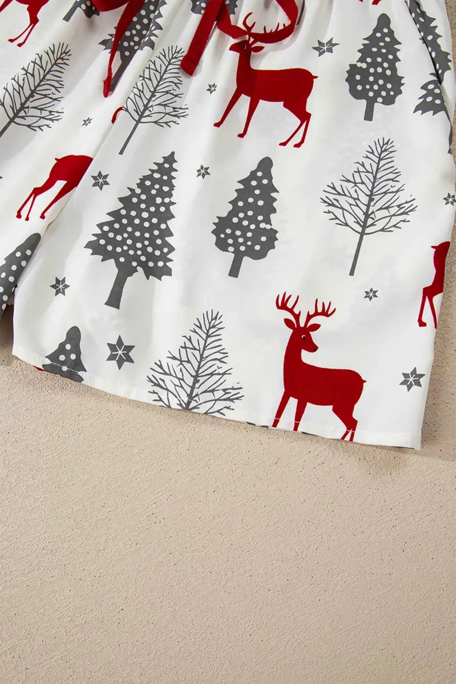 Shorts from Ladies White Christmas Print Velvet Trim Pyjamas featuring red reindeer and grey trees, perfect for festive fall and winter lounging.