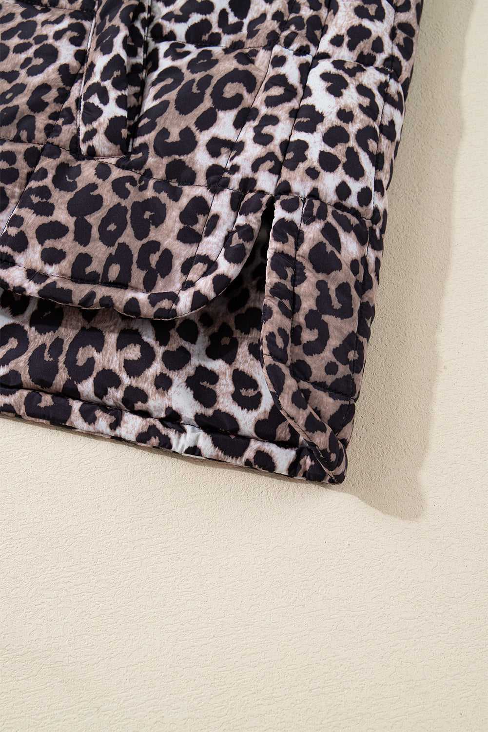 Bottom hem and side slit of Leopard Print Quilted Puffer Gilet. Quilted stitching adds texture to this fashionable vest.