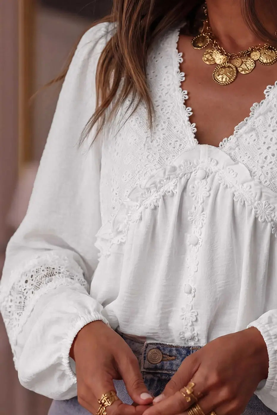 Close-up of the White Guipure Lace Frill Blouse highlighting floral lace trim, fabric-covered buttons, and frilled detailing on the bodice.