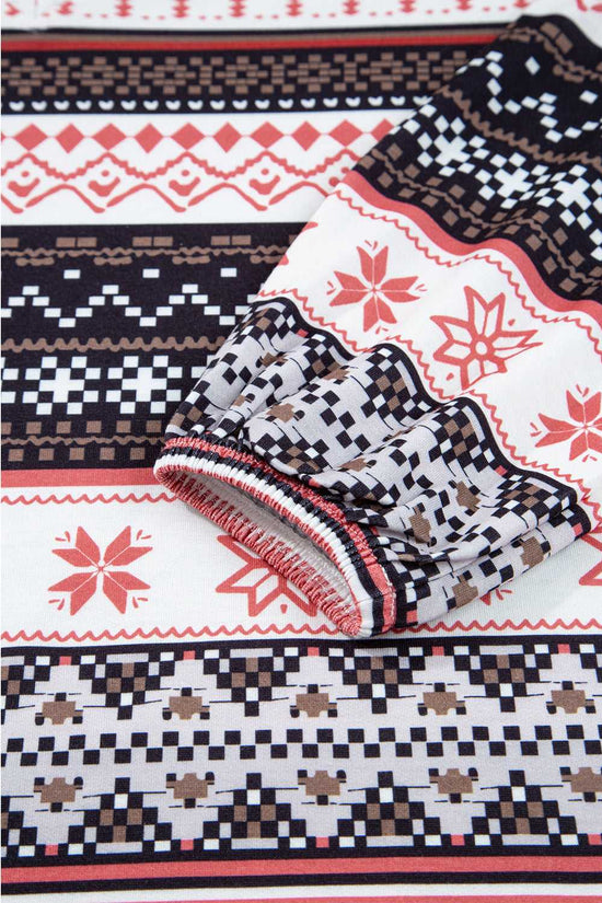 Fabric close-up of Women's Christmas Comfort Lounge Set in Black by FashionFitz, displaying soft texture and intricate holiday pattern.