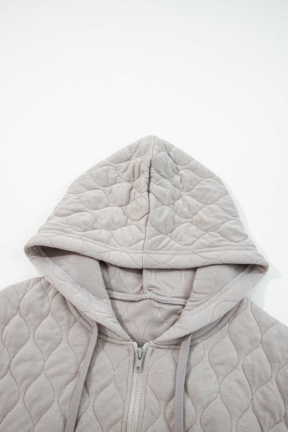 Top view of hood on curve grey quilted quarter-zip hoodie, showcasing soft quilted fabric and relaxed fit for plus size women.