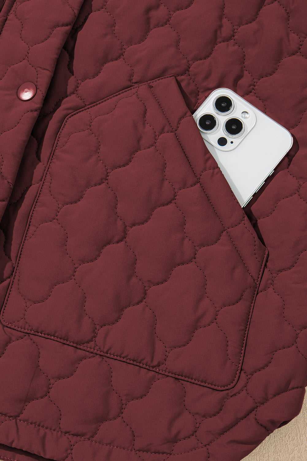 Burgundy Flower‑Quilted Winter Gilet with phone in front pocket, highlighting practical storage and floral quilted texture for women’s vests.