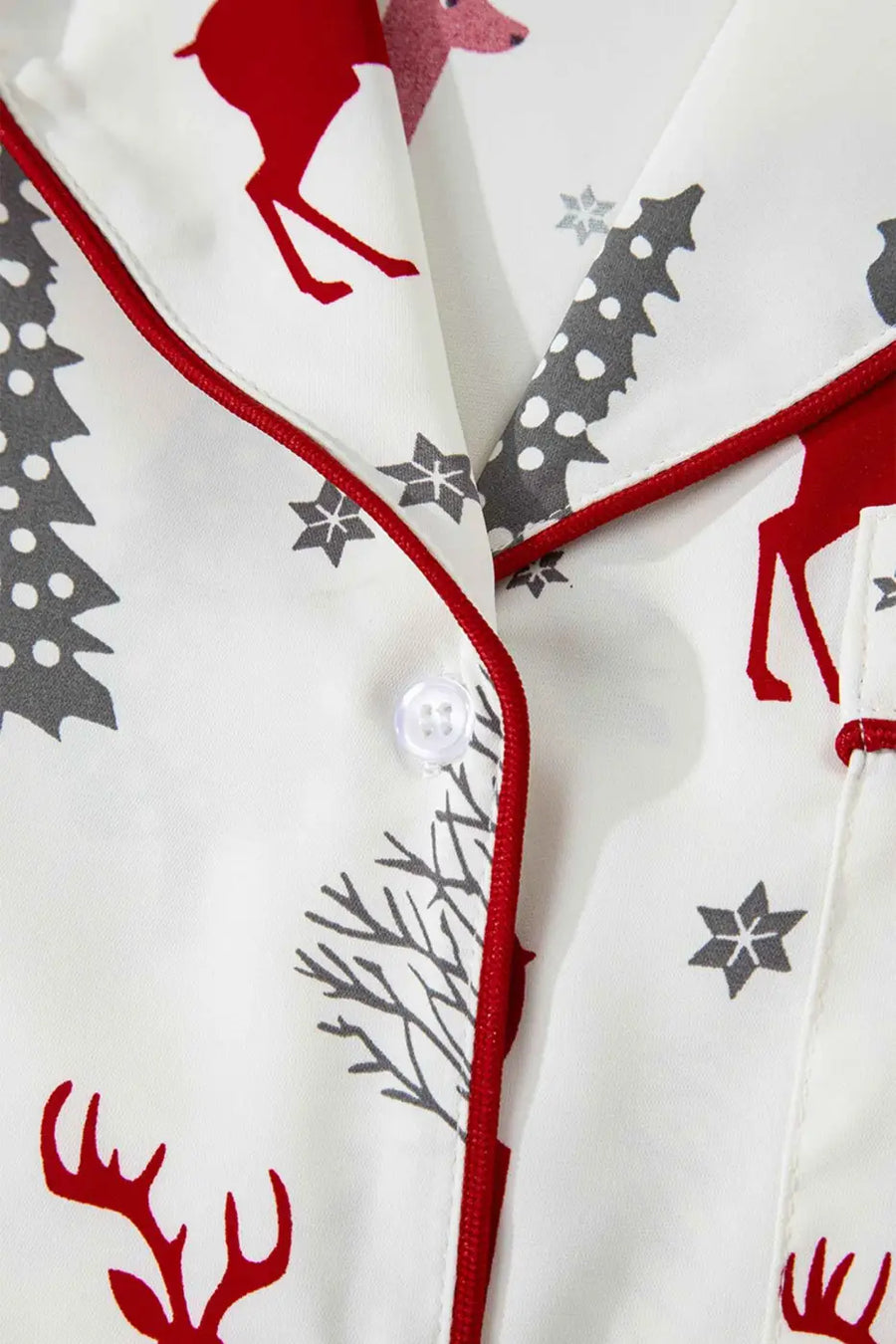 Front button detail on White Christmas Print Velvet Trim Pyjamas with red piping and festive reindeer design, ideal for seasonal sleepwear.