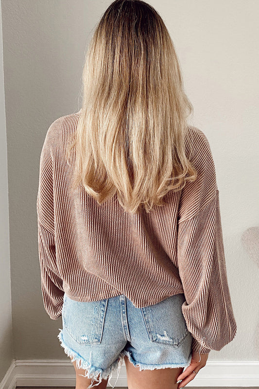Person wearing a Game Day Graphic Crop Top and denim shorts with a neutral background