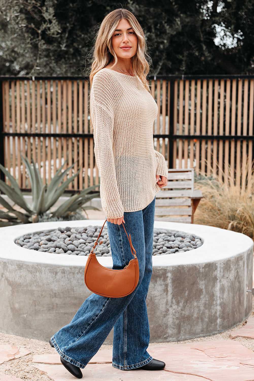 Smoke Gray Crochet Summer Jumper styled with flared jeans and a brown handbag. Lightweight, breathable sweater ideal for casual warm-weather outfits.