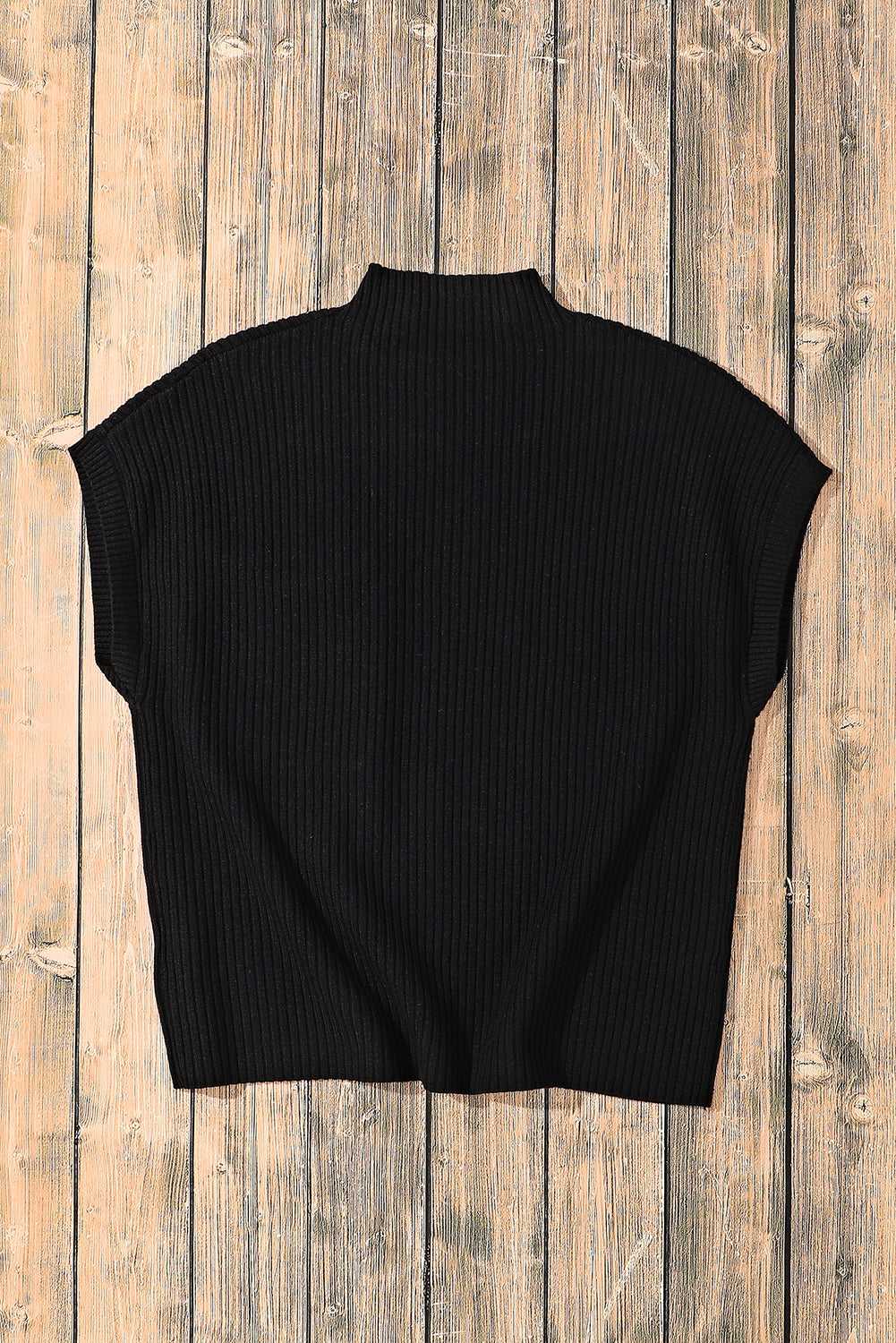 Back flat lay of black ribbed knit short-sleeve top, showcasing its cozy texture and relaxed silhouette.