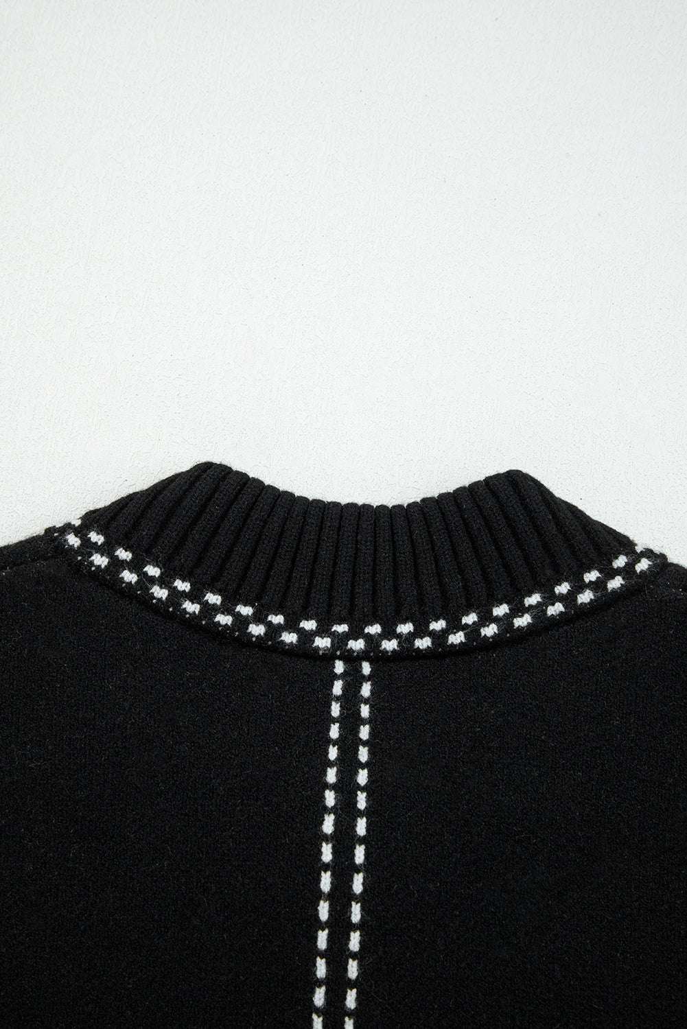 Detailed view of back neckline on Women's Black Contrast Trim Knitted Cardigan highlighting ribbed collar and contrast stitching.