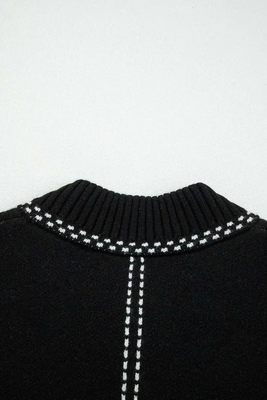 Detailed view of back neckline on Women's Black Contrast Trim Knitted Cardigan highlighting ribbed collar and contrast stitching.