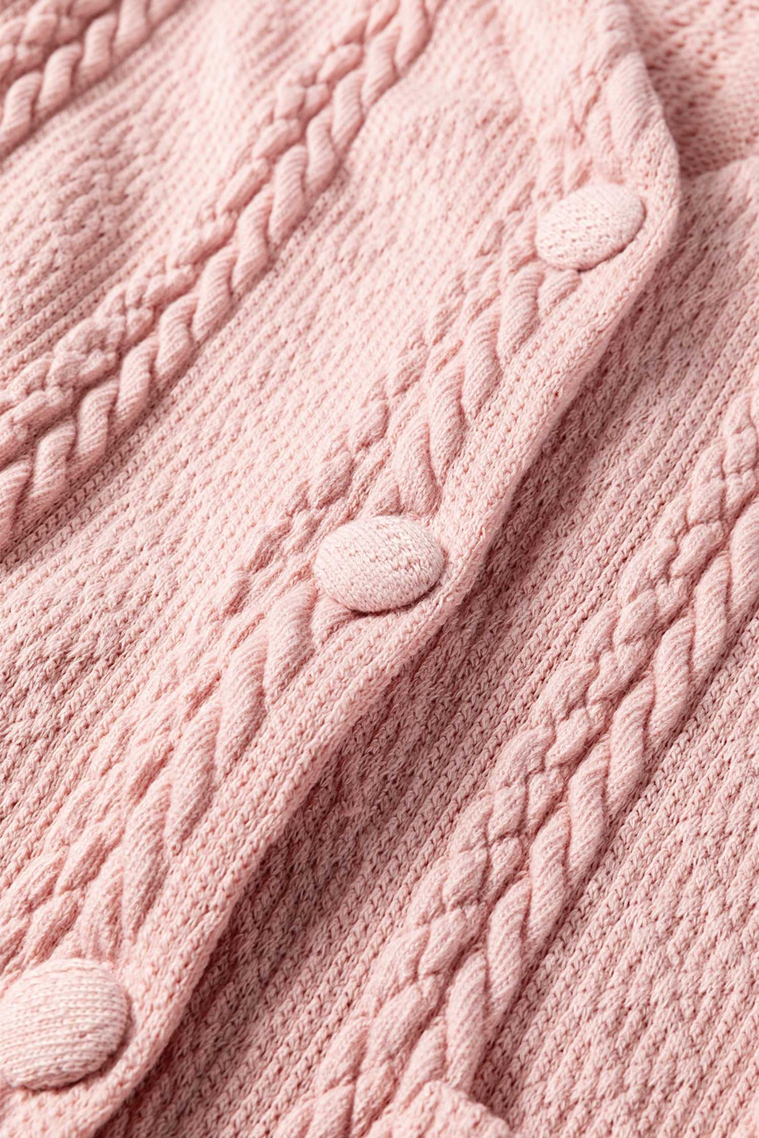 Close-up of the Blush Pink Cable Knit Co‑Ord buttons and textured cable knit fabric, emphasizing the quality and detail of the knitwear.
