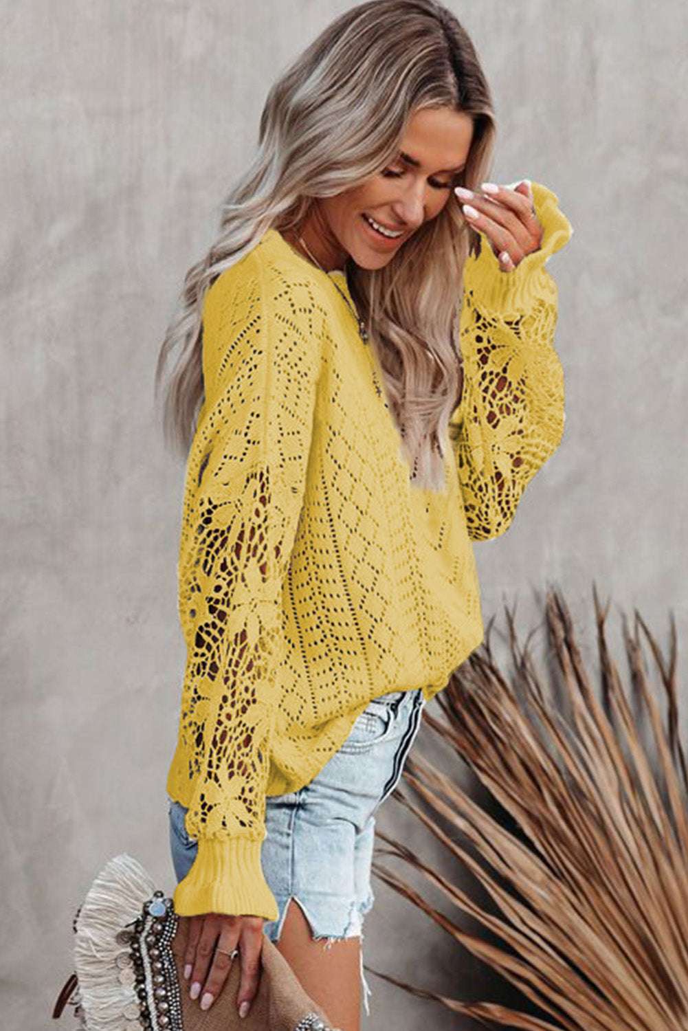 Side profile of Yellow Crochet Lace Pointelle Knit Sweater paired with shorts, highlighting floral lace sleeves and breathable knit texture.