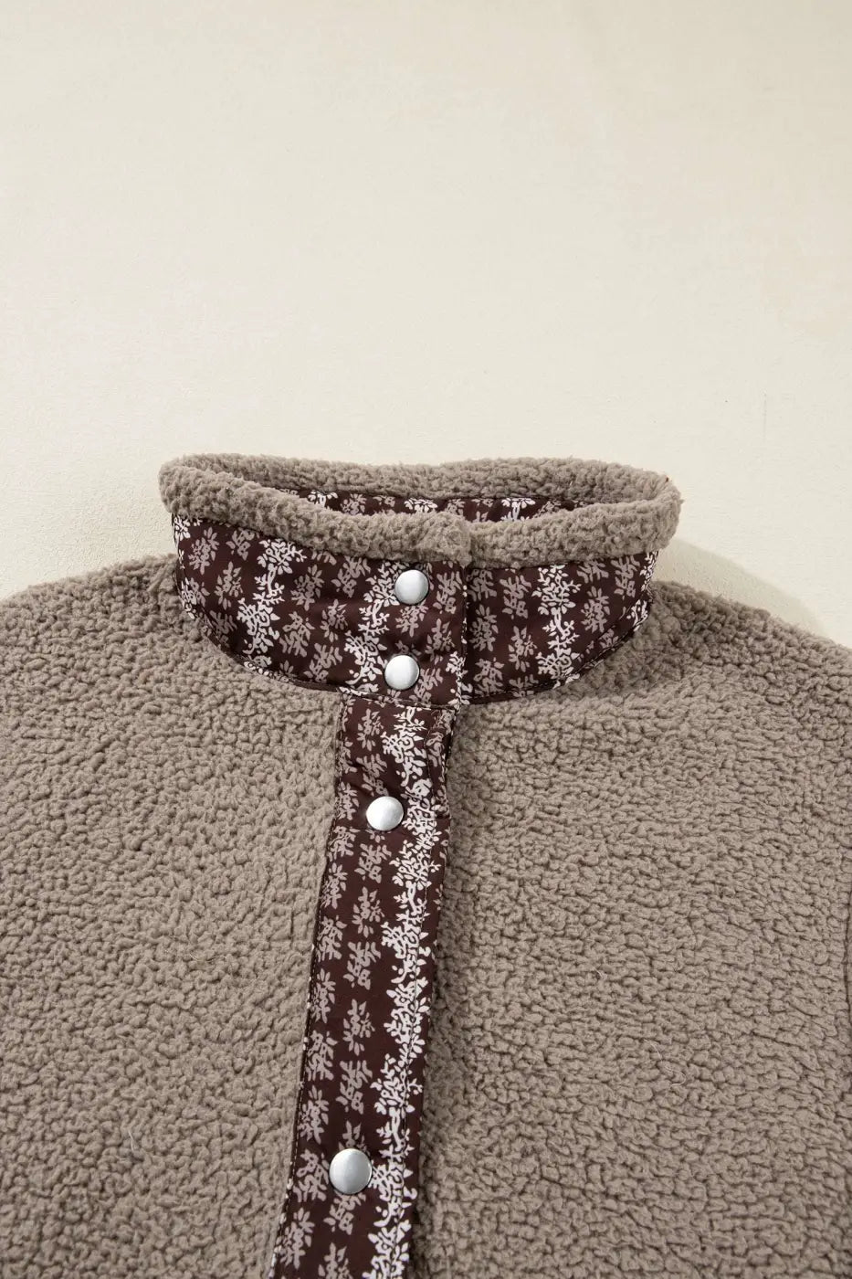 Close-up of collar and snap buttons on Women's Country Borg Fleece Gilet Winter Vest FashionFitz with brown floral trim detail.