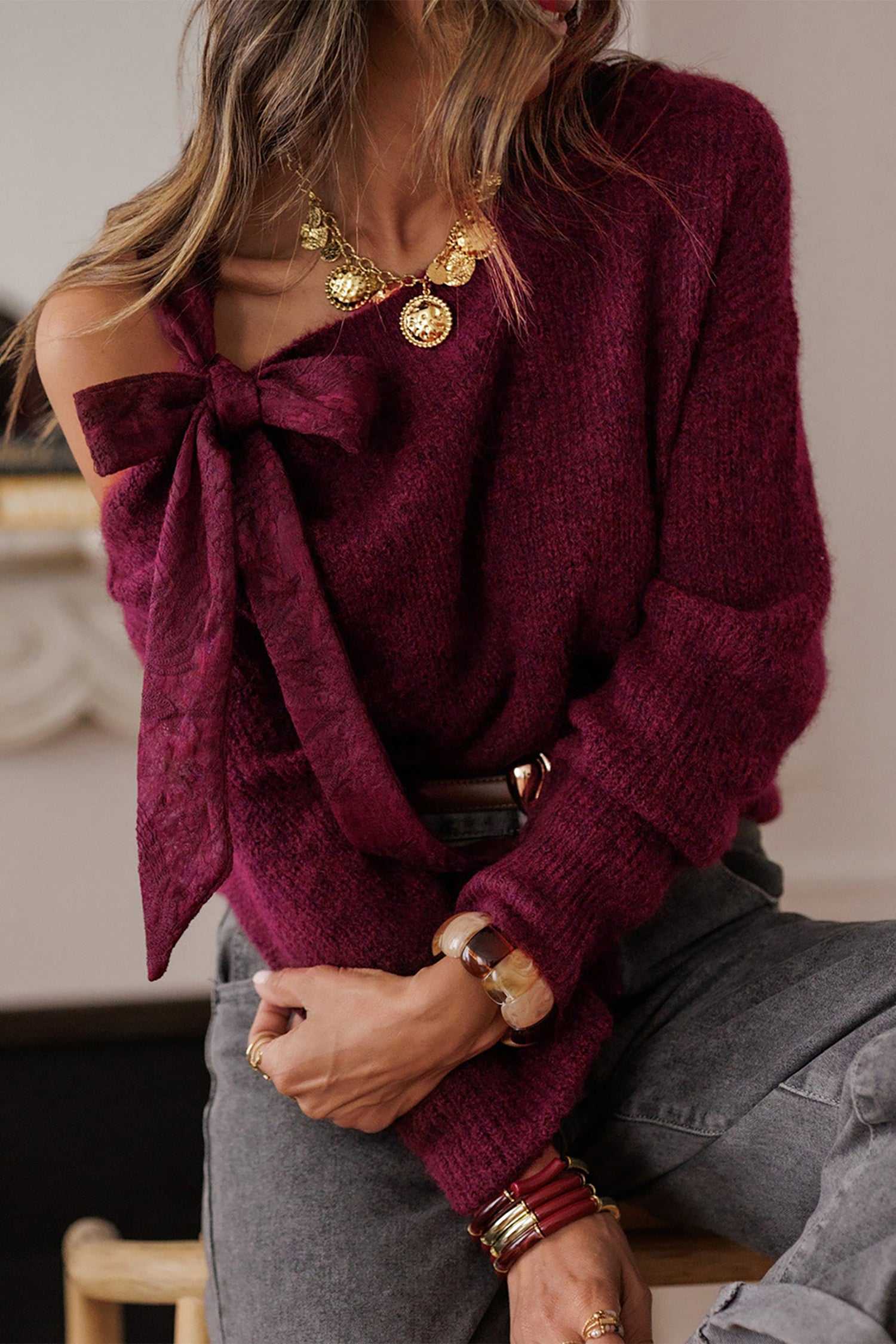 Chic burgundy lace bow sweater with long sleeves and off-shoulder cut. Feminine autumn knitwear for stylish night-out or casual occasions.