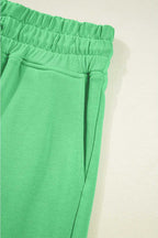 Side pocket and waistband detail of green Drop Crop Pants, perfect for casual wear with practical storage.