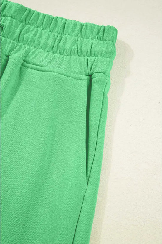 Side pocket and waistband detail of green Drop Crop Pants, perfect for casual wear with practical storage.