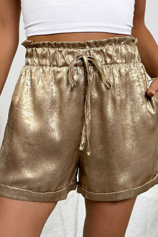 Gold Metallic Shorts Women styled with frilled high waist and drawstring, designed for casual-glam summer fashion and festival wear.