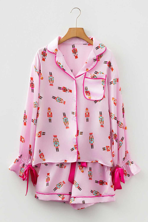 Two-piece satin pyjamas in pink with whimsical holiday print