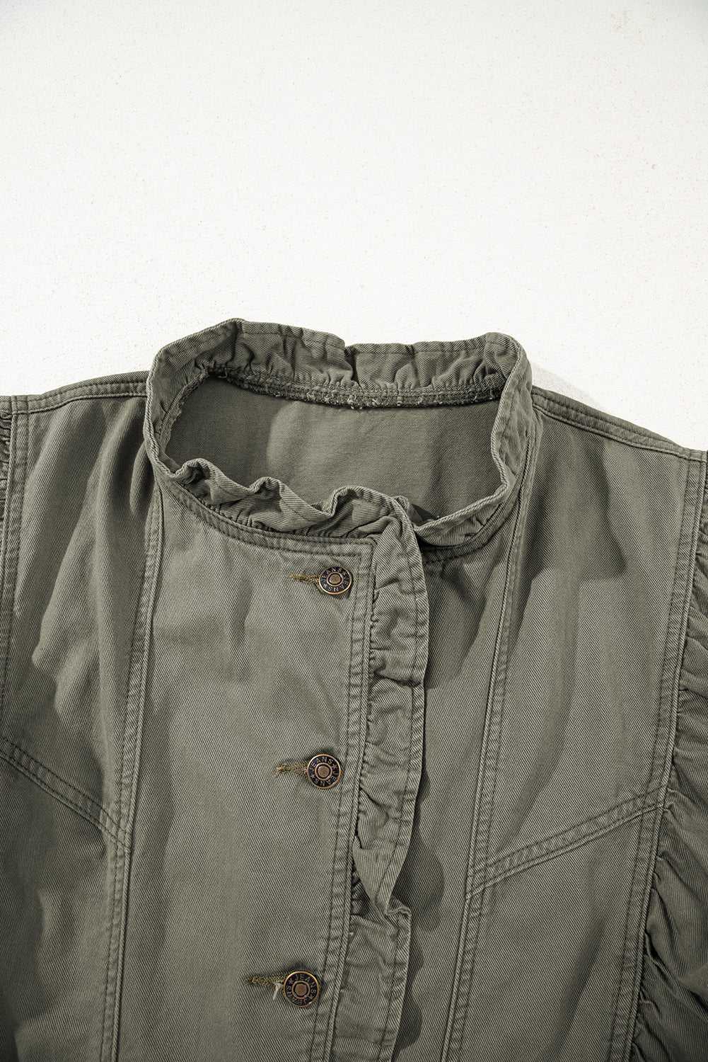 Close-up of collar and buttons on Green Bay Ruffled Denim Vest - Women's Fashion Trends, featuring ruffled neckline and vintage-style hardware.