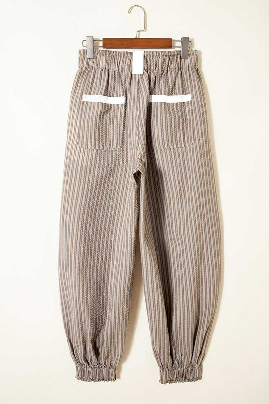 Rear flat lay of Brown Stripe Cargo Joggers with elastic cuffs and white-accented back pockets.