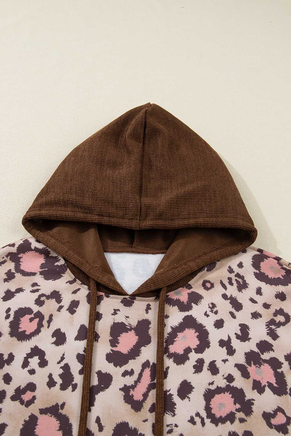 Detail view of hood on Curve Brown Leopard Knit Panel Hoodie for Women, showcasing brown knit texture and drawstring for casual wear.