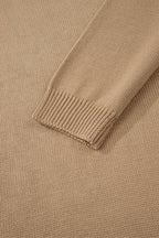 Close-up of a beige sweater with ribbed trim