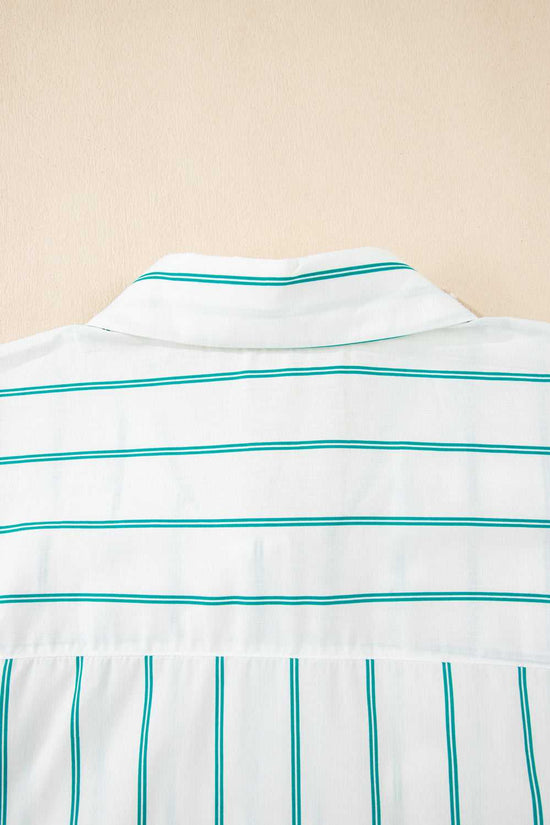 Close-up of a white shirt with green stripes on a beige background