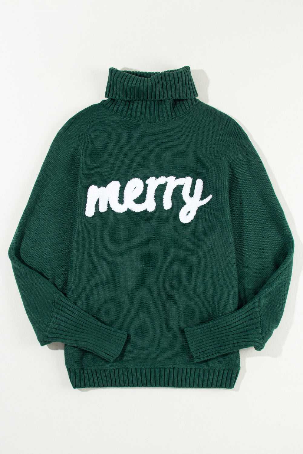 Flat lay of green Stylish High Neck Red Sweater - Christmas, featuring bold white 'merry' text and ribbed cuffs for a festive winter look.
