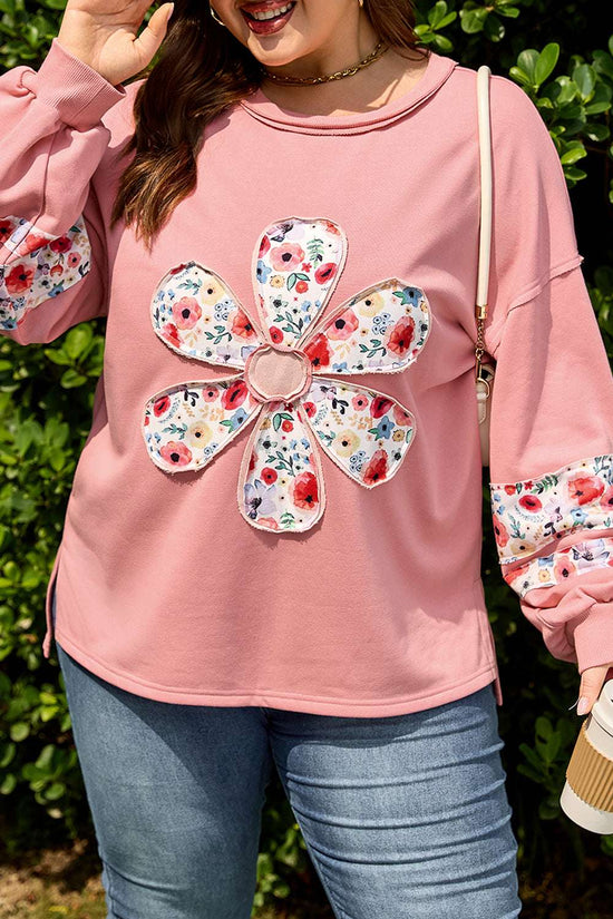 Close-up of Curve Blush Peach Floral Appliqué Sweatshirt for Women showing detailed floral appliqué design and soft peach fabric texture.