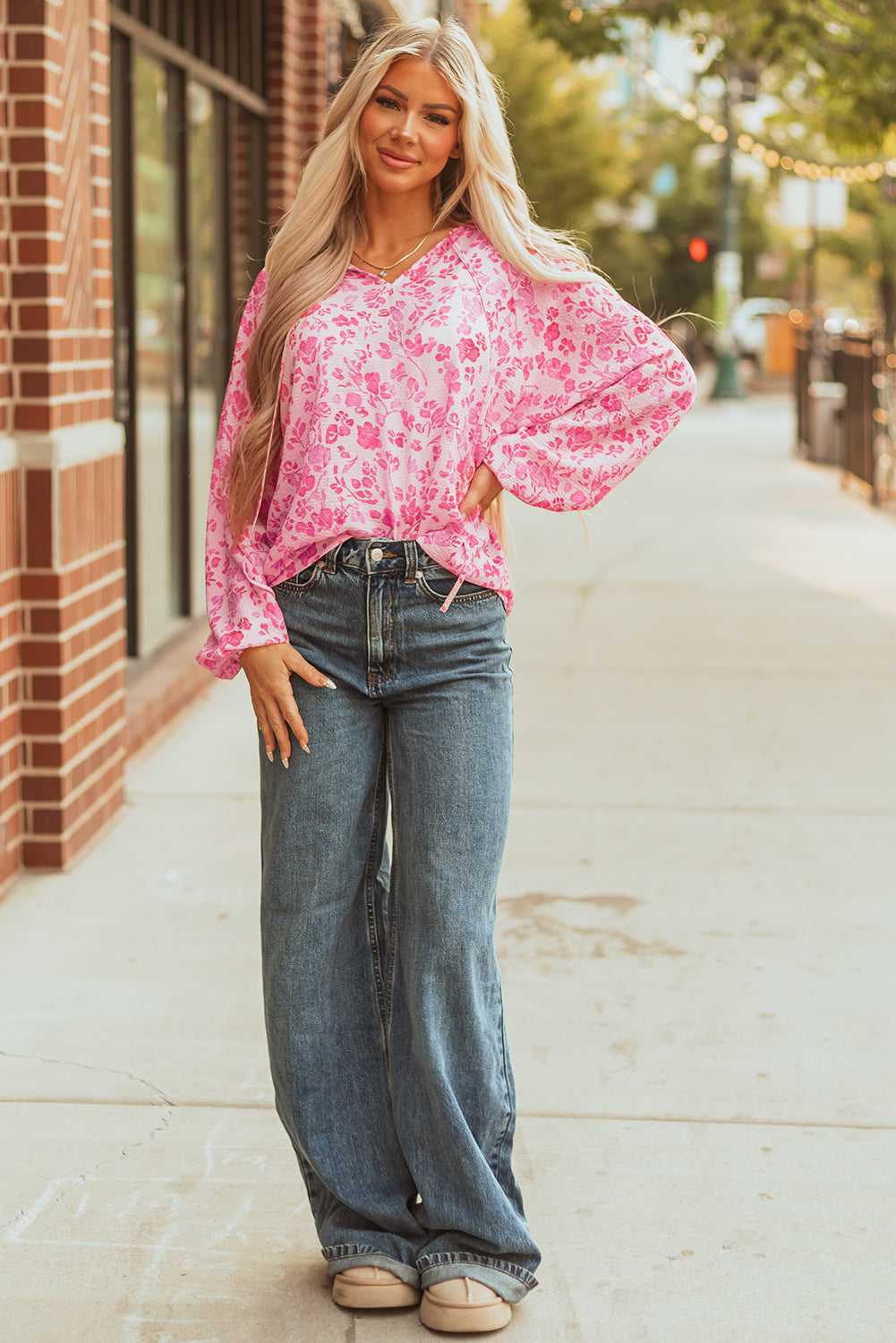 Model in Pink Floral Lightweight Blouse with relaxed fit and vibrant floral print, styled for everyday elegance.
