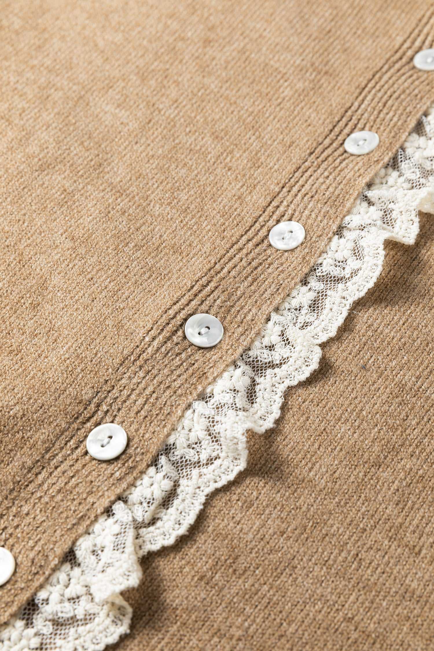 Detailed view of lace trim and buttons on taupe knit cardigan. Women’s lace detail knitwear for stylish and cozy layering.