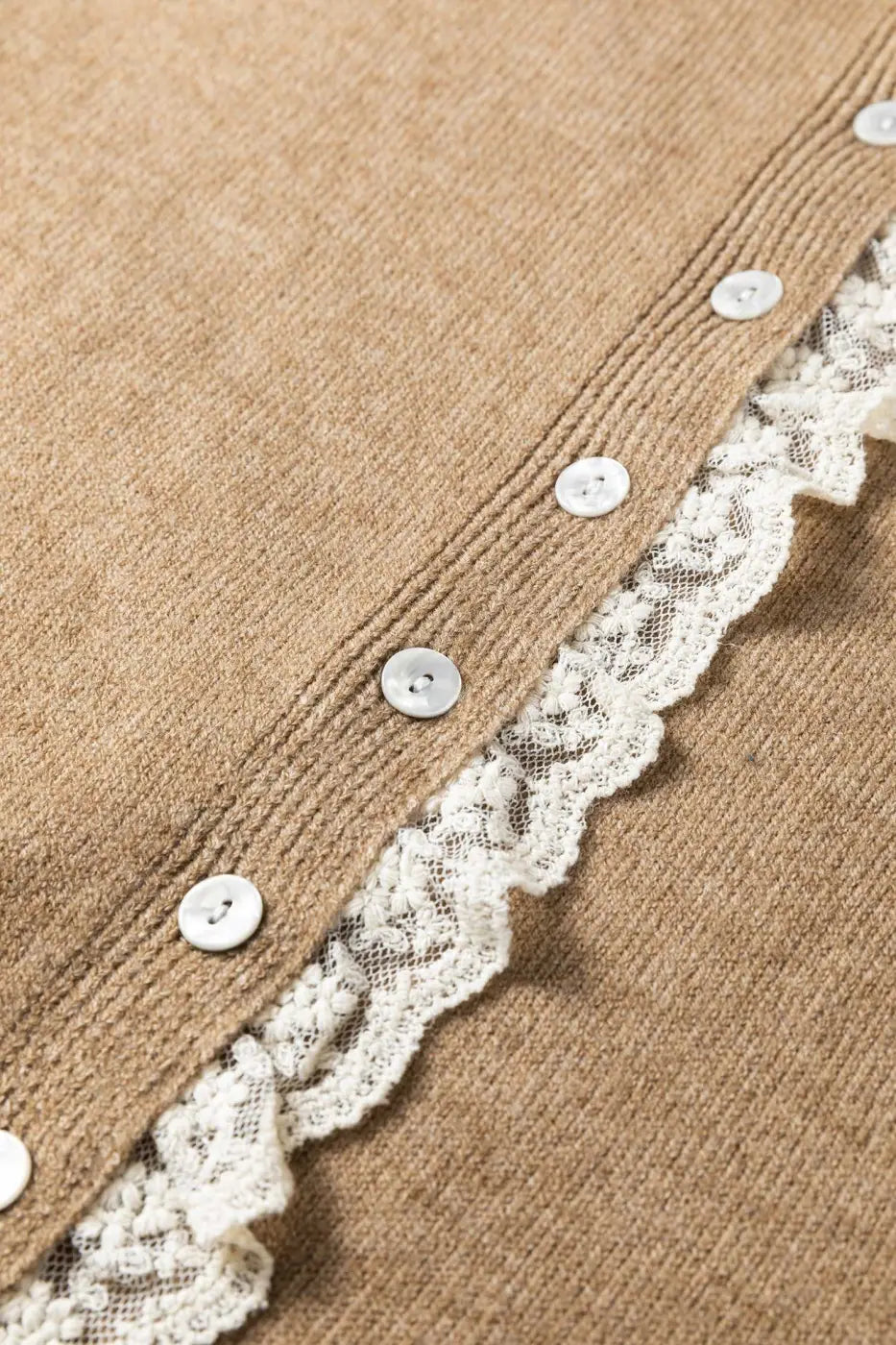 Detailed view of lace trim and buttons on taupe knit cardigan. Women’s lace detail knitwear for stylish and cozy layering.