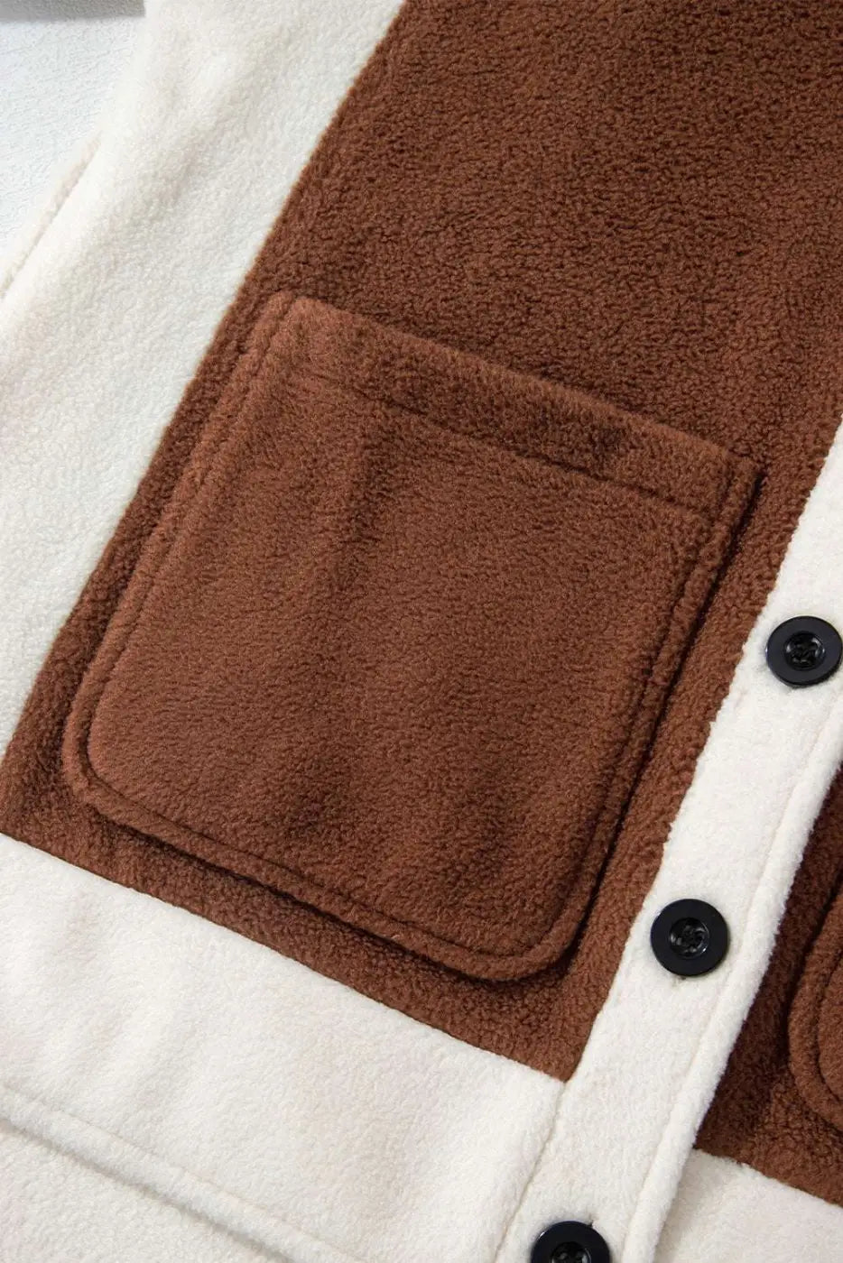 Close-up of front pocket and button panel on Ladies Brown Panels Fleece Shacket Winter Casual, highlighting patchwork and color block design.