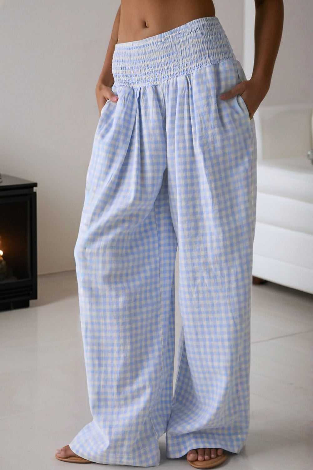 Model wearing plaid wide-leg trousers with elastic waist and relaxed fit