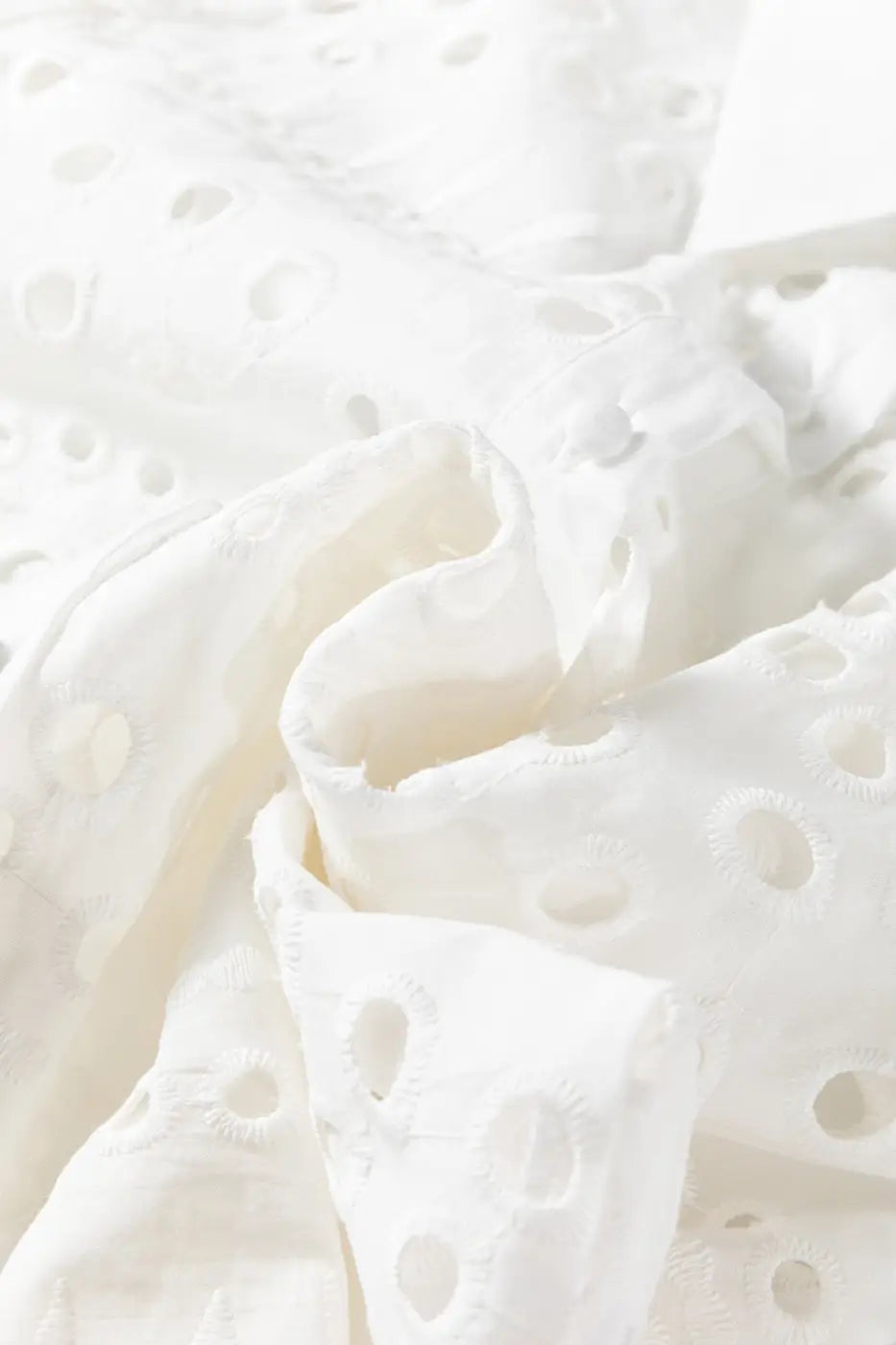 Fabric detail of White Cutwork Embroidered Crop Top, showing soft cotton texture and intricate cutwork embroidery.