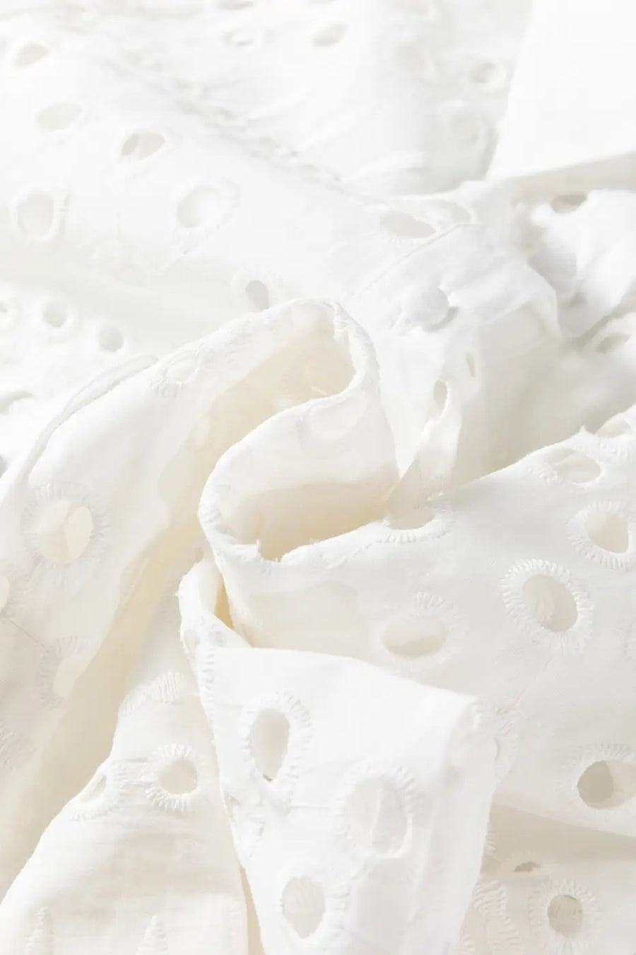 Fabric detail of White Cutwork Embroidered Crop Top, showing soft cotton texture and intricate cutwork embroidery.