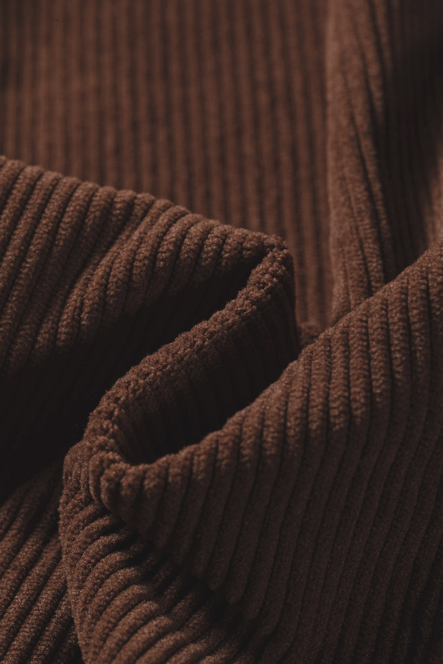 Corduroy shacket detail — button closure and ruffle collar trim