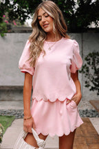 Woman wearing a pink skort set with scalloped hem outdoors
