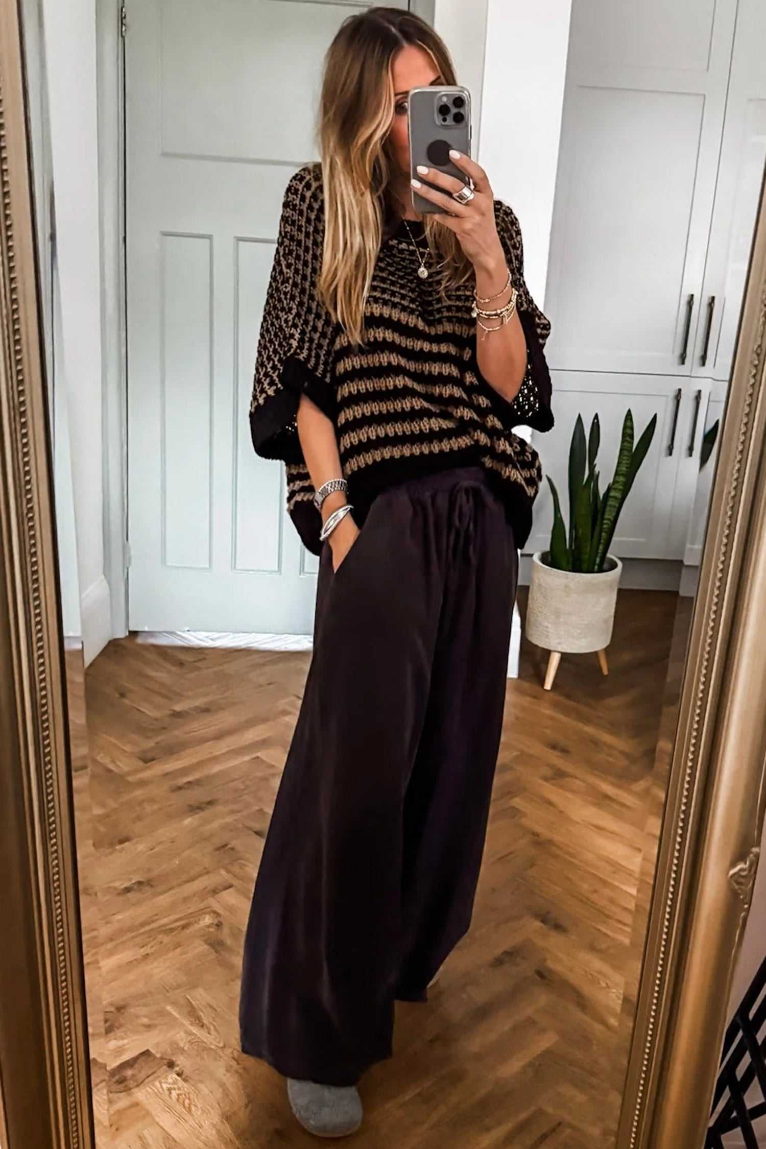 Relaxed fit black striped Soft‑Knit Slouchy Jumper for Women paired with wide-leg pants, perfect for daily fashion.