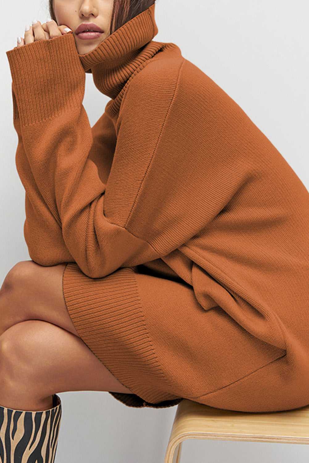 Person wearing a brown Oversized Turtleneck Jumper Dress sitting on a chair.