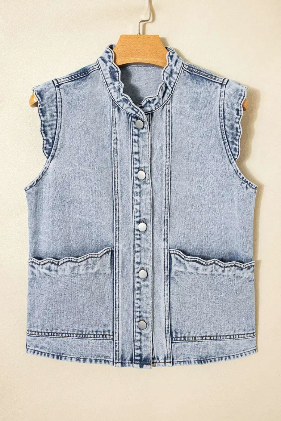 Flat lay of Beau Blue Scallop‑Trim Denim Waistcoat on hanger, featuring scallop trim collar and front flap pockets in soft denim.