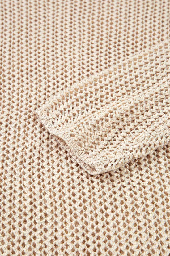Close-up of beige textured fabric with a folded corner