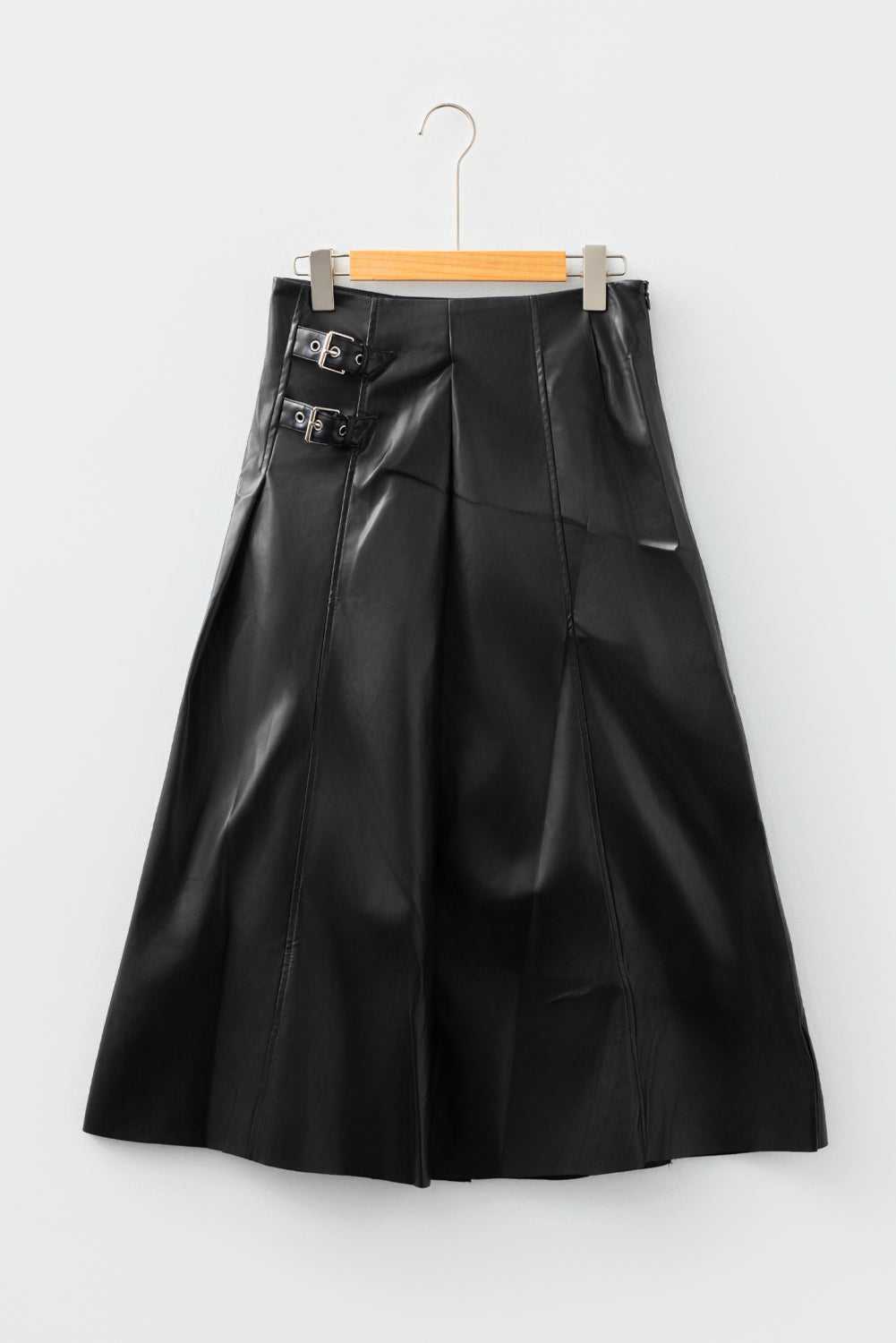 Black Faux Leather Pleated Flared Skirt | FashionFitz product-only front view on hanger, showing structured pleats and dual buckle waist detail.
