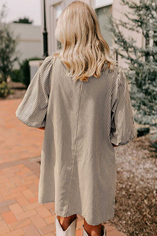 Back view of monochrome striped puff sleeve mini dress showing relaxed fit and lightweight fabric, perfect for casual summer styling.