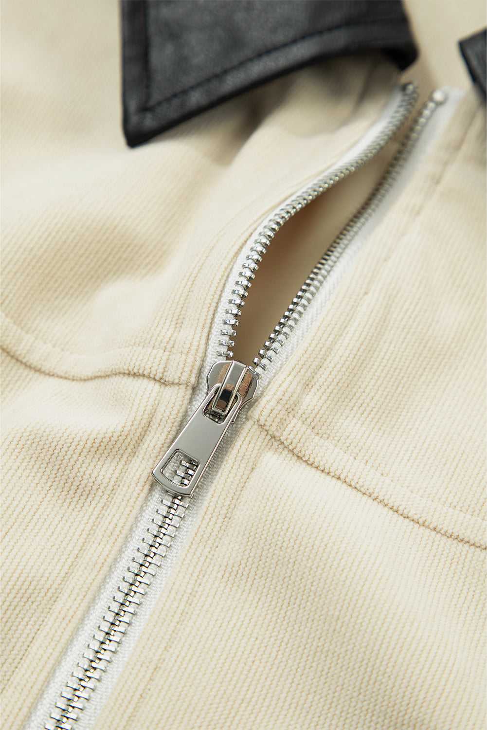 Detailed view of the silver zipper on the Leather Collar Corduroy Jacket, highlighting quality hardware and soft corduroy fabric.